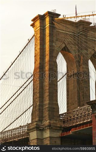 Close up of a pillar of the Brooklyn bridge at sunset, New York City, USA