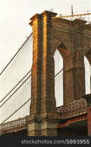 Close up of a pillar of the Brooklyn bridge at sunset, New York City, USA