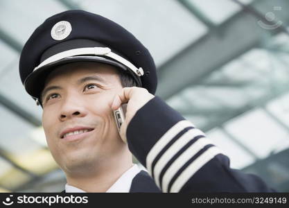 Close-up of a pilot talking on a mobile phone