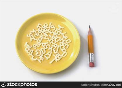 Close-up of a plate and a pencil