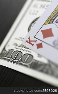 Close-up of a playing card on an one hundred dollar bill