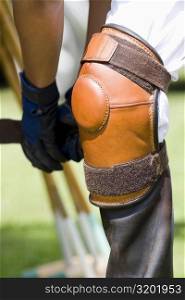 Close-up of a polo player tying riding boots