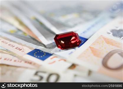 Close-up of a precious stone with Euro Dollar bills