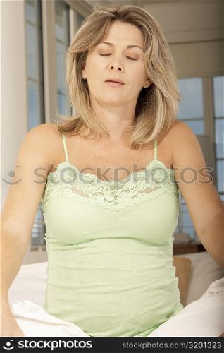 Close-up of a pregnant mid adult woman meditating