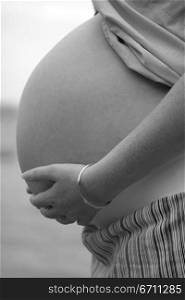 Close up of a pregnant woman holding her stomach