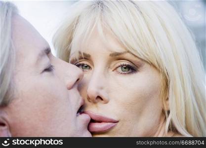 Close up of a pretty woman kissing a man