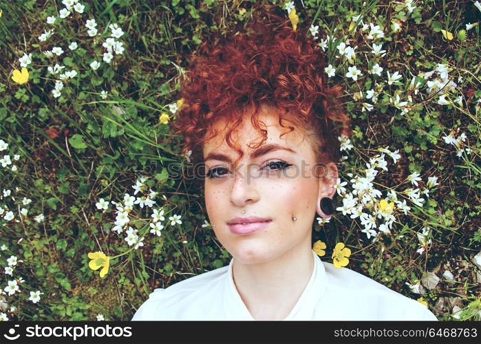 Close up of a pretty young woman in a field of flowers