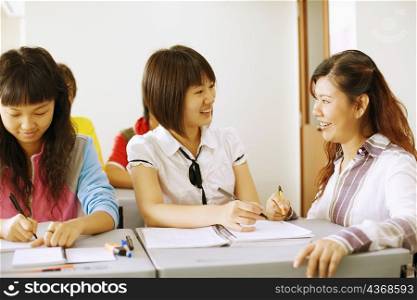 Close-up of a professor teaching her student in the classroom