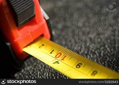 Close-up of a red and yellow tape measure.
