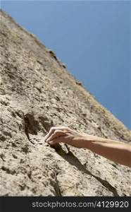 Close-up of a rock climber&acute;s hand gripping on a rock