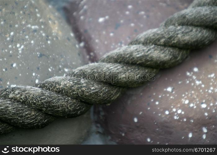Close-up of a rope against a stone surface