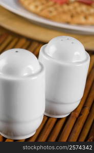 Close-up of a salt shaker and a pepper shaker