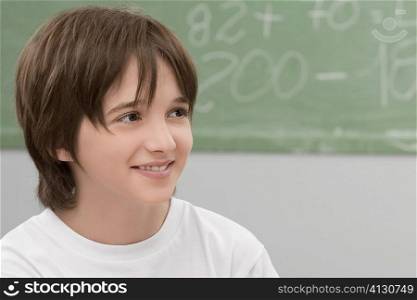 Close-up of a schoolboy smiling in a classroom