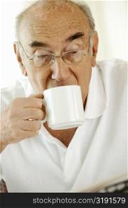 Close-up of a senior man drinking a cup of a coffee