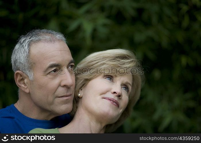 Close-up of a senior man embracing a mature woman