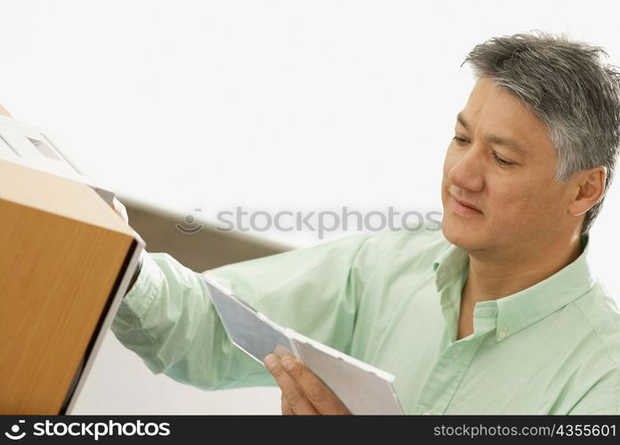 Close-up of a senior man holding a CD Case