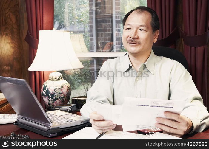 Close-up of a senior man holding a letter