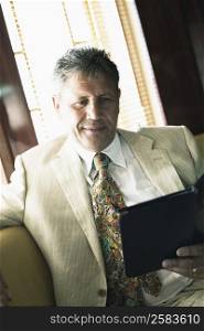 Close-up of a senior man holding a menu