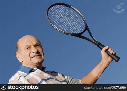 Close-up of a senior man holding a tennis racket