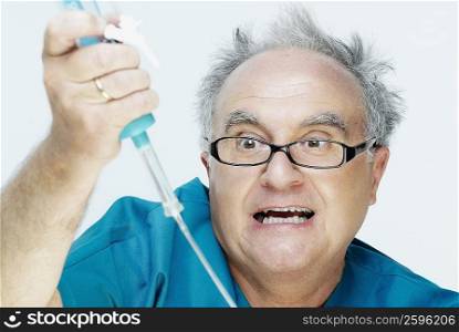 Close-up of a senior man holding an iv drip and making a face