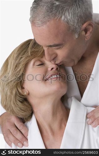 Close-up of a senior man kissing a mature woman&acute;s nose