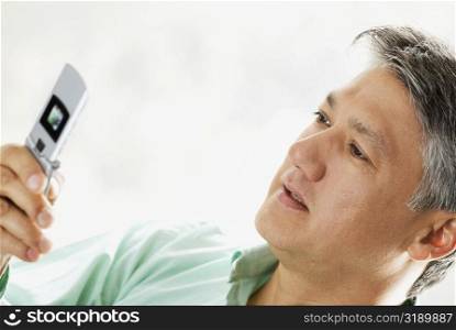 Close-up of a senior man looking at a mobile phone