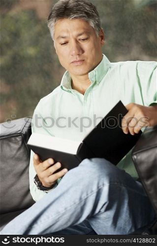 Close-up of a senior man reading a book