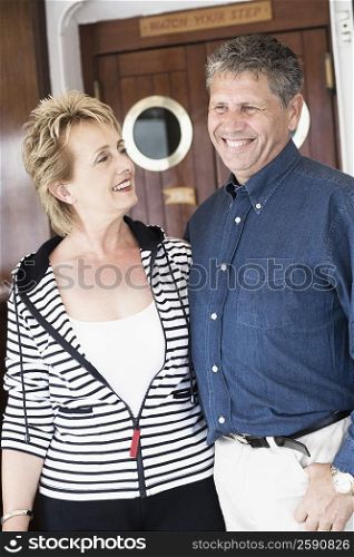 Close-up of a senior man standing with a mature woman and smiling