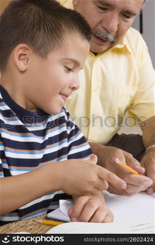 Close-up of a senior man teaching his grandson