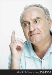Close-up of a senior man thinking and gesturing