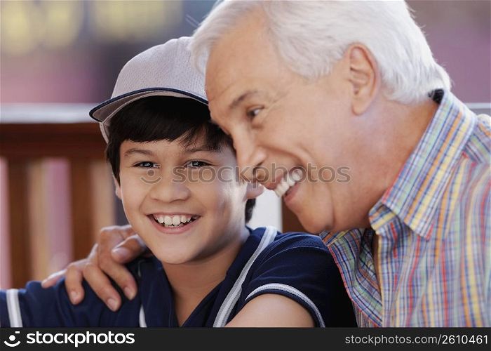 Close-up of a senior man with his grandson in a restaurant