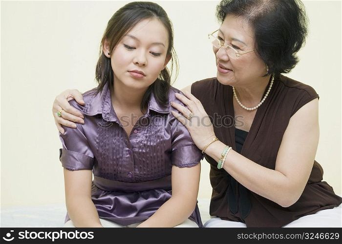 Close-up of a senior woman consoling her daughter