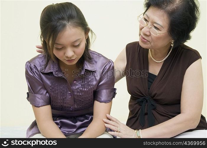 Close-up of a senior woman consoling her daughter