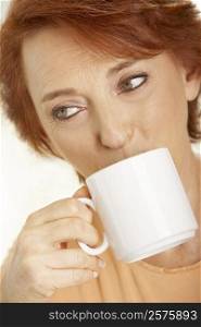 Close-up of a senior woman drinking a cup of coffee
