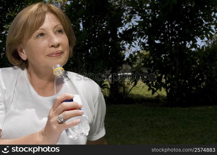 Close-up of a senior woman drinking water