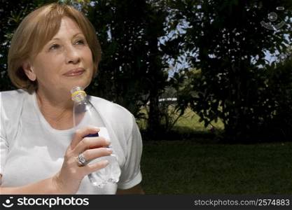 Close-up of a senior woman drinking water