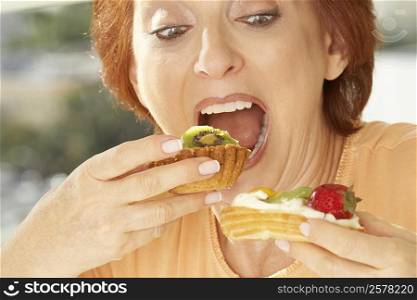Close-up of a senior woman eating a fruit tart