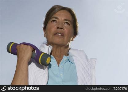 Close-up of a senior woman exercising with a dumbbell