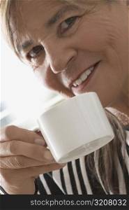 Close-up of a senior woman having coffee