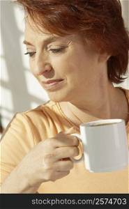 Close-up of a senior woman holding a cup of coffee