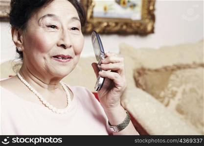 Close-up of a senior woman holding a mobile phone