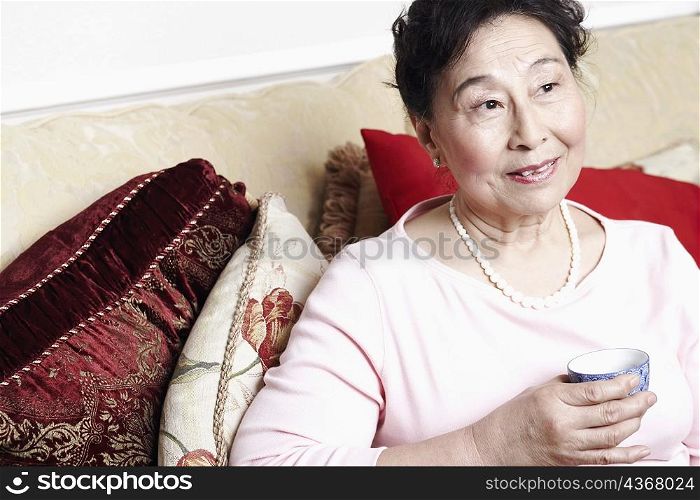 Close-up of a senior woman holding a tea cup