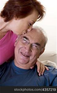 Close-up of a senior woman kissing a senior man