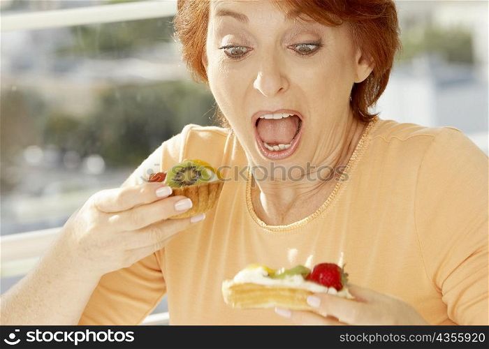 Close-up of a senior woman looking at a fruit tart