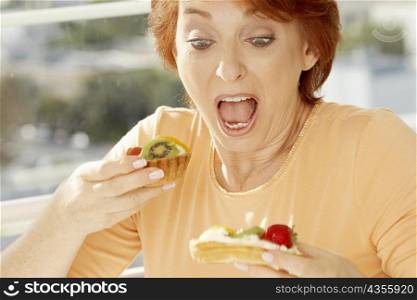 Close-up of a senior woman looking at a fruit tart