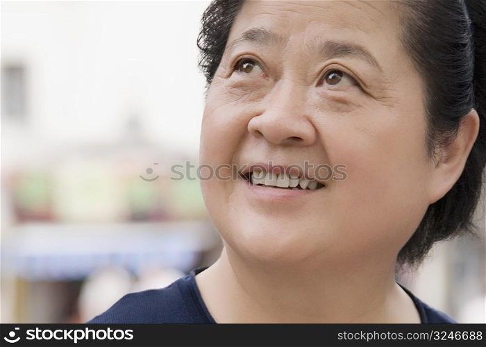 Close-up of a senior woman looking up and smiling