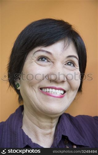 Close-up of a senior woman smiling and looking up