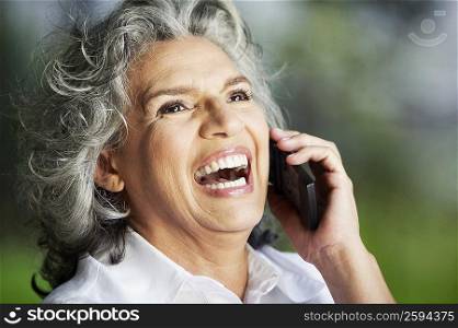 Close-up of a senior woman talking on a mobile phone and laughing