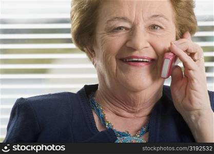 Close-up of a senior woman talking on a mobile phone and smiling
