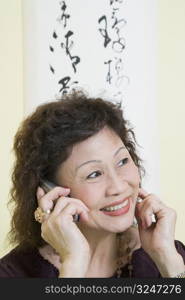 Close-up of a senior woman using a mobile phone and smiling